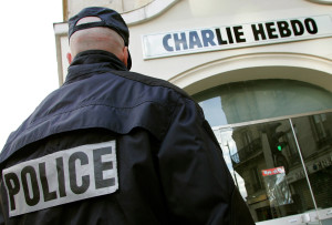 File photo of a policeman standing guard outside the French satirical weekly "Charlie Hebdo" in Paris