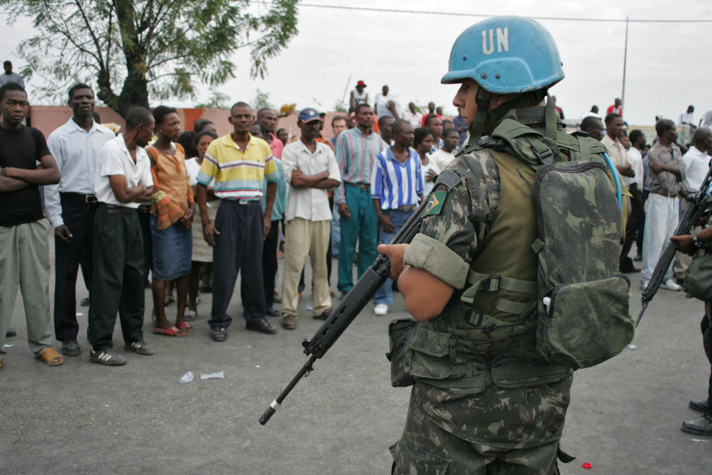 A United Nations peacekeeper from Brazil guards a voting center Tuesday, February 7, 2006 during presidential and parliamentary elections in Port-au-Prince, Haiti. Haitians voted for president today in the first election since Jean-Bertrand Aristide was driven from power two years ago, with the prospect that United Nations forces will remain essential to the country no matter who wins. Photographer: Oscar Sosa/Bloomberg News