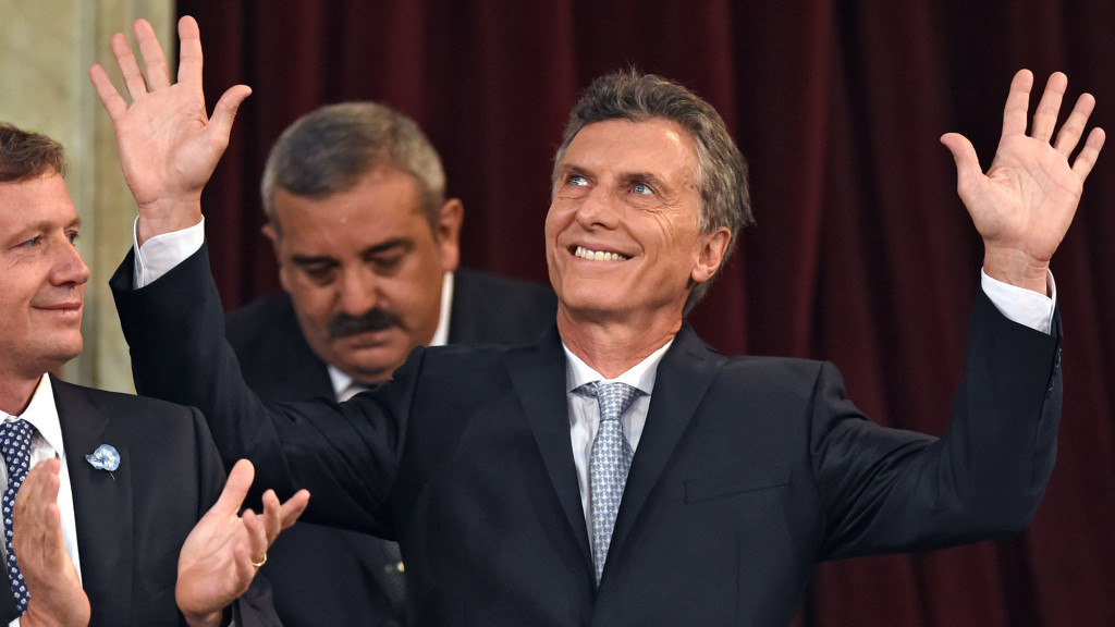 Argentine President-elect Mauricio Macri waves during his inauguration ceremony at the Congress in Buenos Aires on December 10, 2015. Macri's inauguration marks the start of a new era for Argentina: a tilt to the right after 12 years under Kirchner and her late husband Nestor, the left-wing power couple that led the country back to stability after an economic meltdown in 2001.At left Emilio Monzo, president of the lower chamber. AFP PHOTO/EITAN ABRAMOVICH